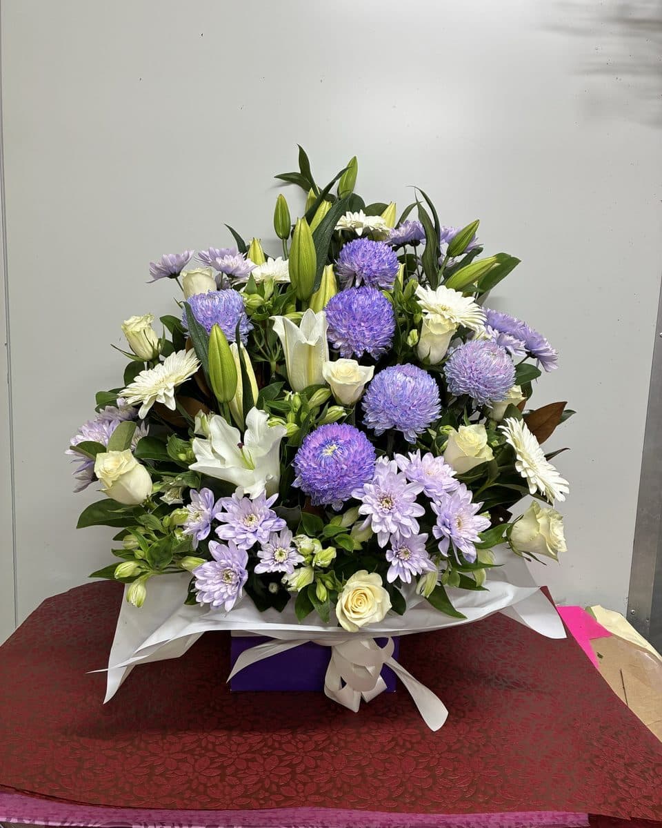 Lilac and white box arrangement: purple chrysanthemums, white roses, lilies and lisianthus